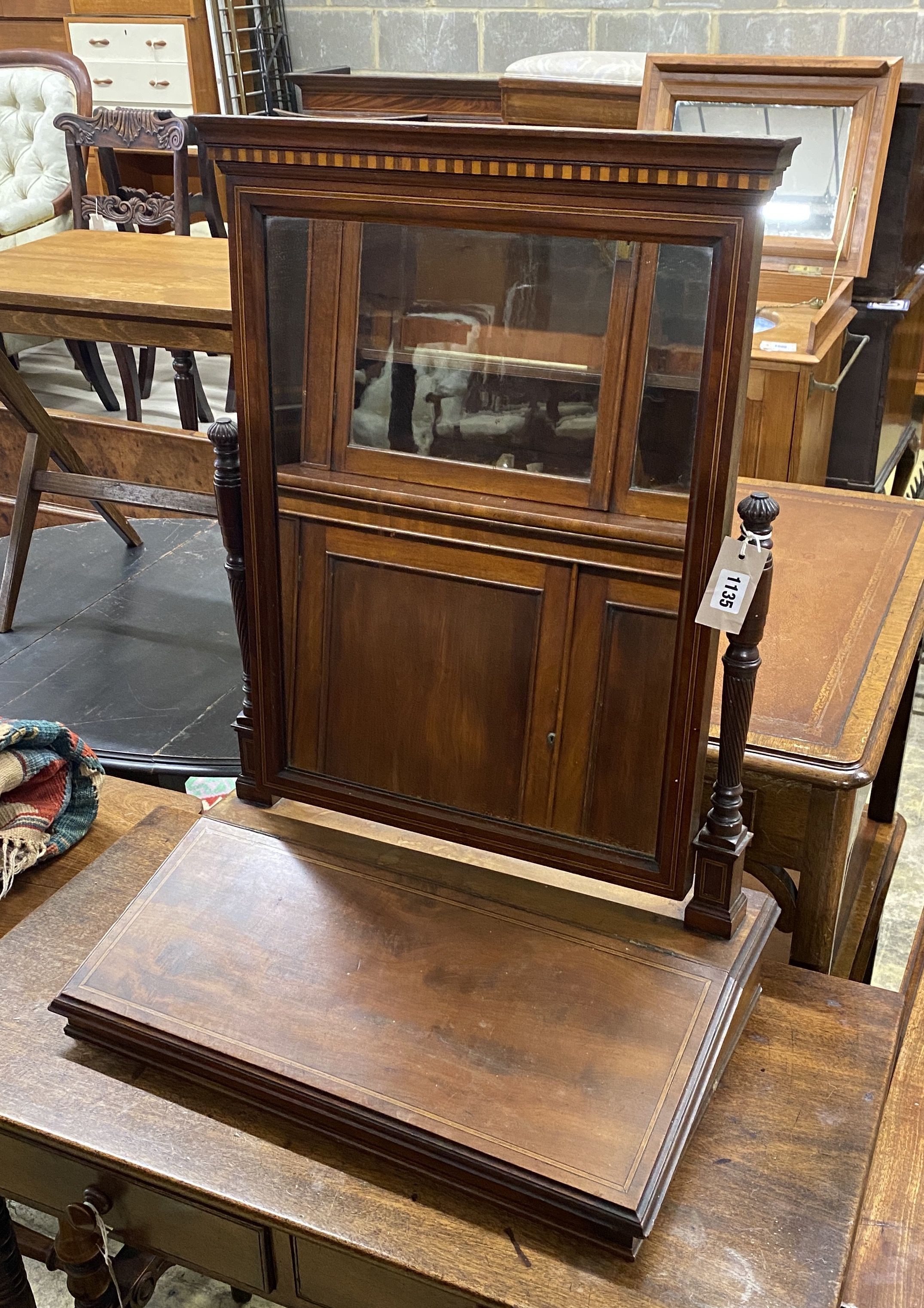 A late Victorian mahogany toilet mirror with hinged box base, width 56cm, depth 34cm, height 73cm